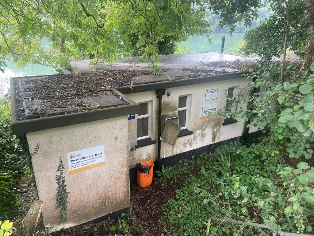 Lot: 104 - FORMER PUBLIC CONVENIENCES WITH FANTASTIC RIVER FAL VIEWS - Front elevation of detached toilet block from alternative angle